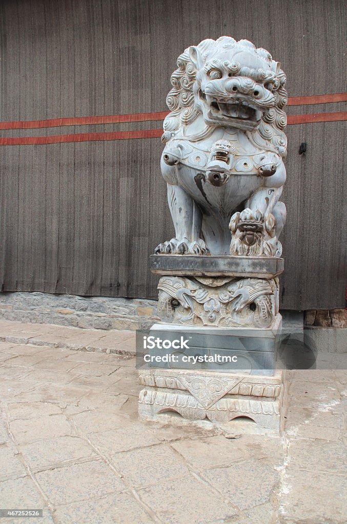 Lion statue at Sakya Monastery, Tibet Female lion statue has a cub under the closer (left) paw in front of Sakya Monastery, Tibet 2015 Stock Photo