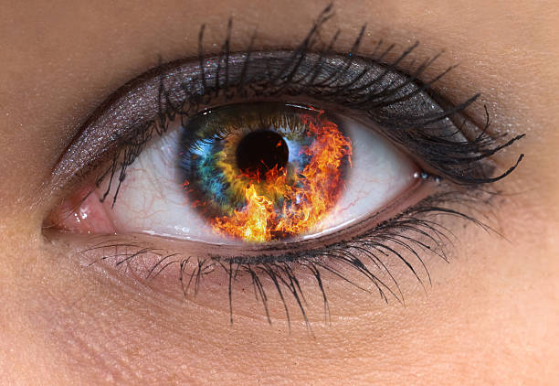 woman eye with fire stock photo