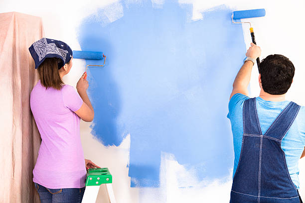 istock Construction: Latin couple. Home improvement projects. Painting a wall. 467253909