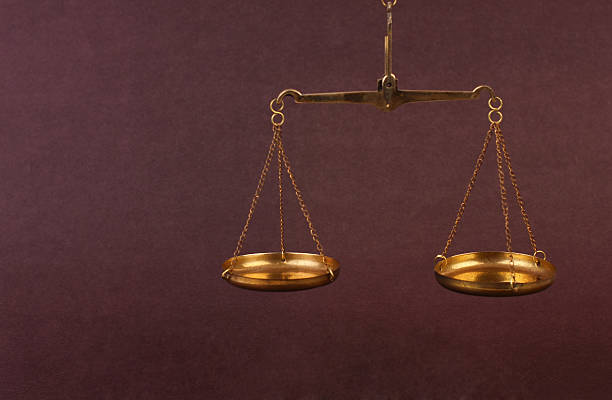 istock Golden balance scale against a purple background 467257090