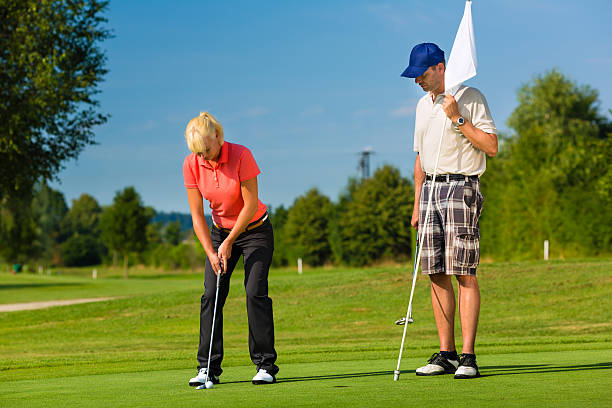 istock Young sportive couple playing golf on a course 467257093