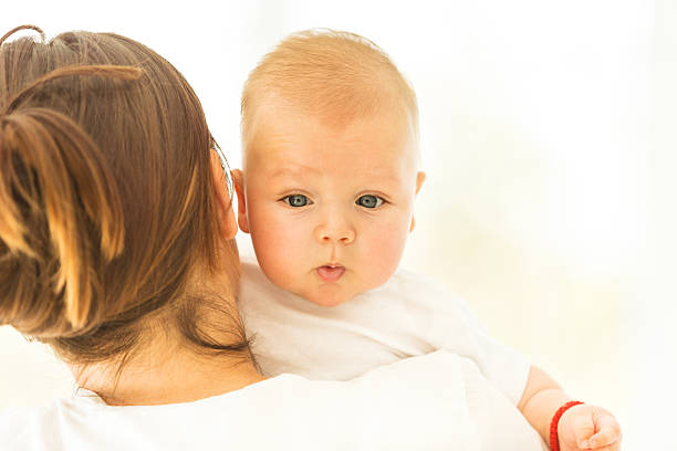 istock Cute three monthts old little boy in mother's arms 467257254
