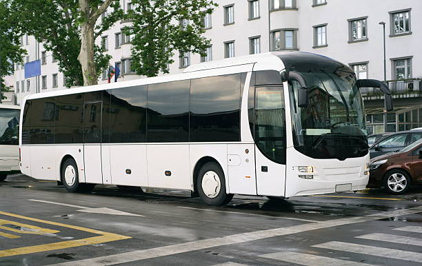 istock White tour bus in a rainy day 467260820