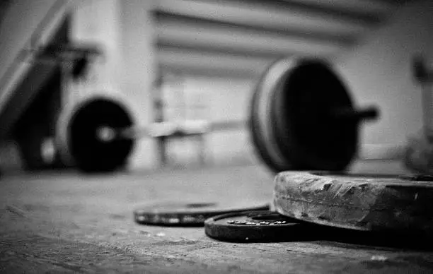 A photo of barbell and discs in a weightlifting gym