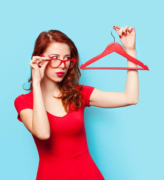 istock Surprised redhead girl with hanger 467267712