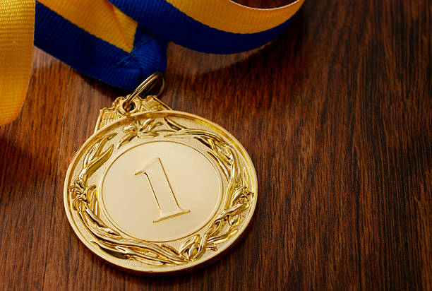 istock Gold medal on a wooden table 467267948