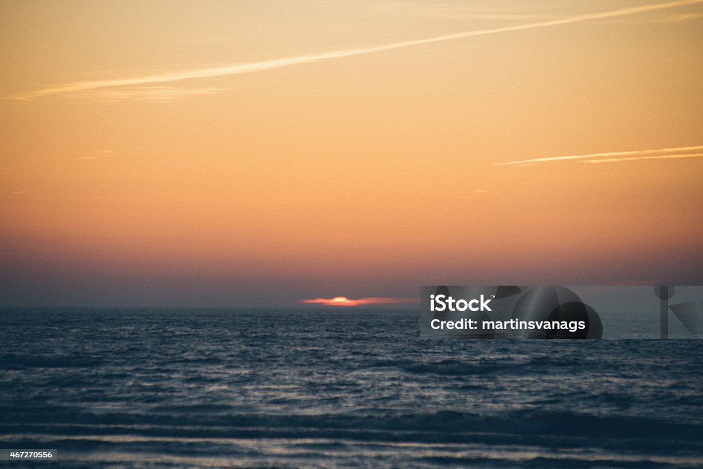 sunset over the sea - grainy retro vintage sunset over the sea with dramatic colorful sky - grainy retro vintage film effect 2015 Stock Photo