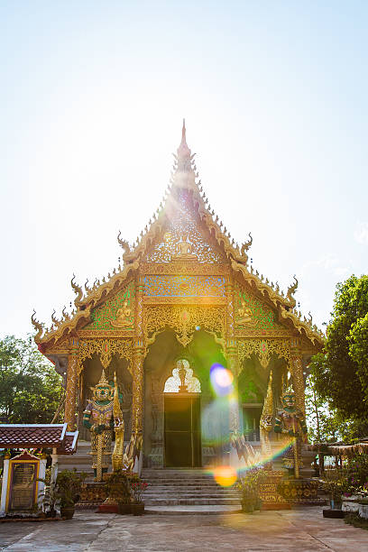 Chiang Rai, Thailand - May 6, 2013: Front of the gold colored temple under backlight in Chiang Rai, Thailand.