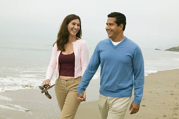 istock Couple Walking Together on Beach 467275669