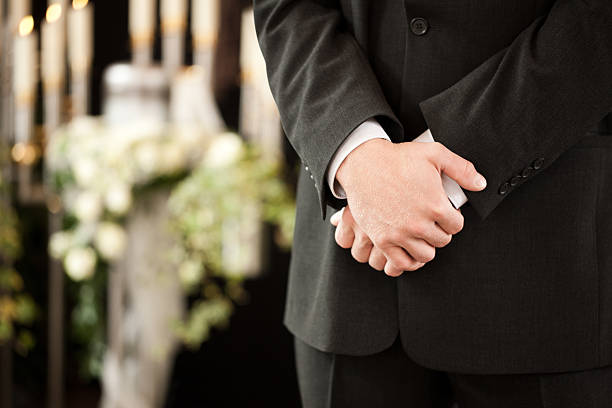 man or mortician at funeral mourning stock photo
