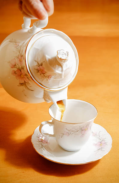 istock pouring tea to a teacup 467279074