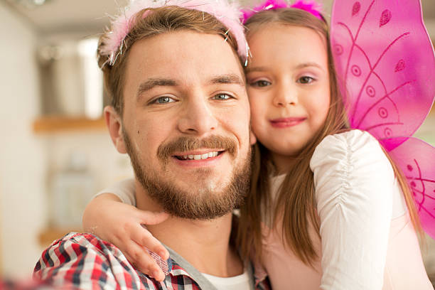 istock Father and daughter in kitchen taking selfies. 467283148
