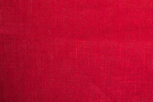 istock Close-up of a sheet of red fabric with some thicker threads 467285874