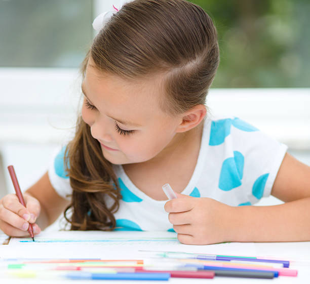 istock Little girl is drawing using pencils 467286101