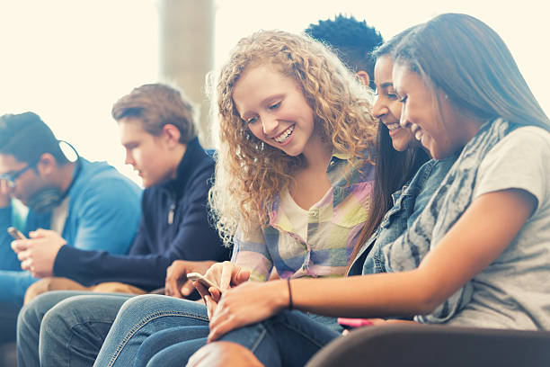 istock Girls using smart phone in high school library together 467286558