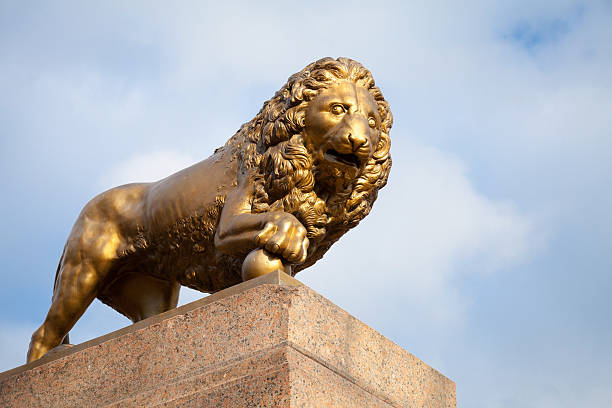 istock Bronze lion with ball, monument on stone base 467286910