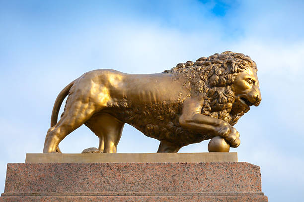 istock Bronze lion with ball, monument on stone base 467286912