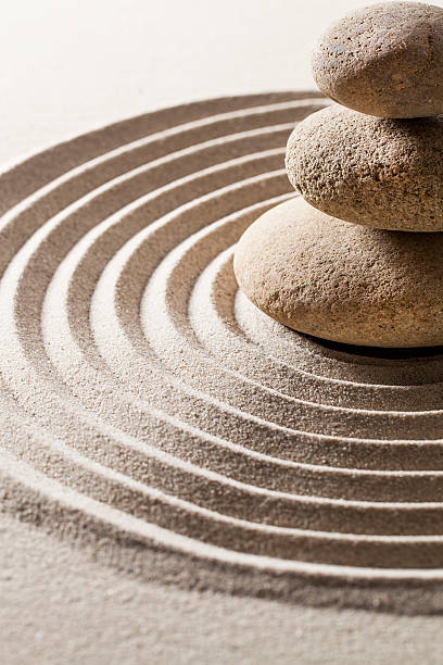 istock Mineral wisdom stones on serene bed of sand. 467287407