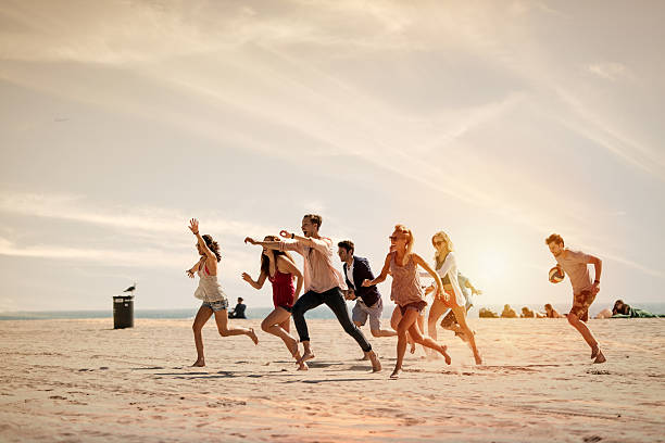 istock Group of friends running at the beach 467288182