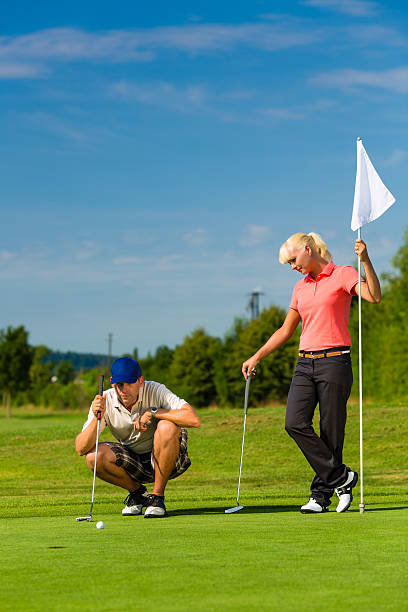 istock Young sportive couple playing golf on a course 467291999