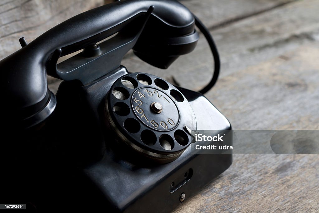 Old retro telephone on vintage boards Old retro telephone on vintage boards closeup 2015 Stock Photo