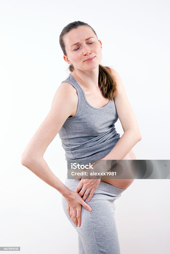 Pregnant woman with strong pain in leg young pregnant woman with ache in leg, on white background 2015 Stock Photo