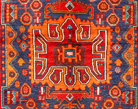 Beautiful ancient oriental colorful carpet with geometric motifs