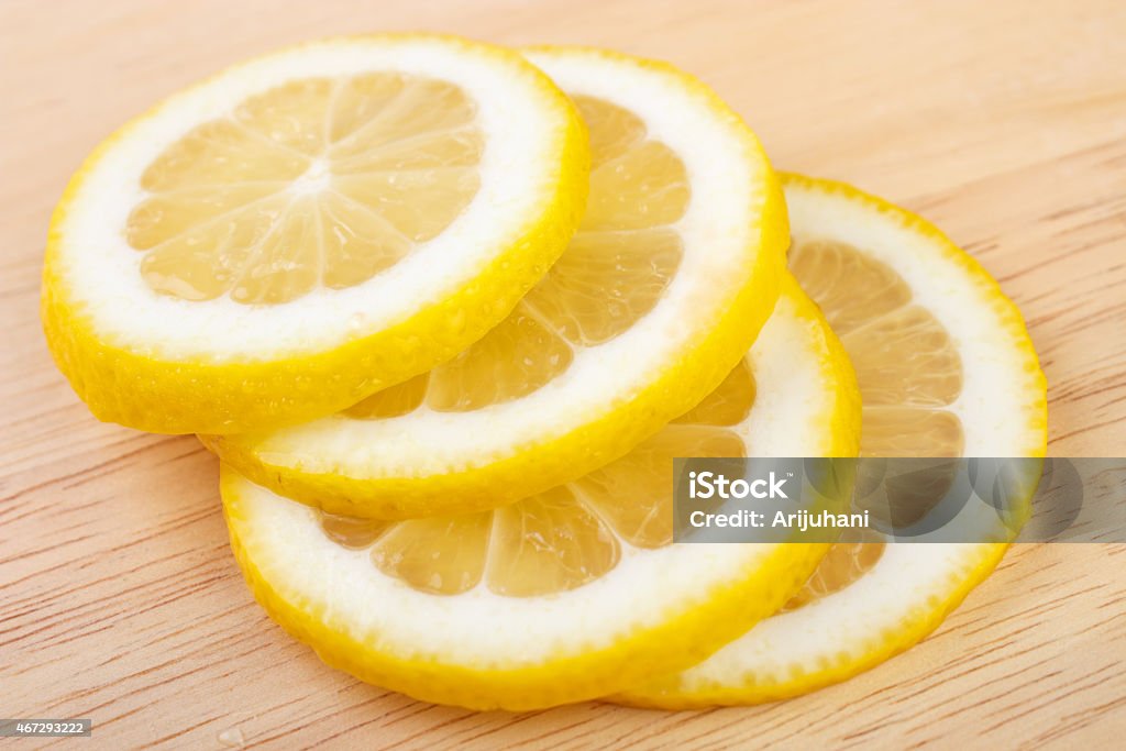 Lemon slices Juicy lemon slices on wooden table 2015 Stock Photo