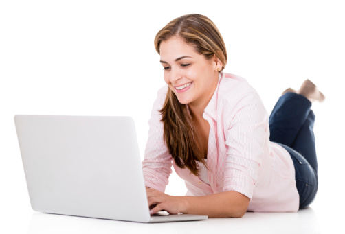 Happy woman using a laptop computer - isolated over white