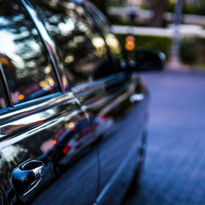 Partial view of a limo, defocused background.