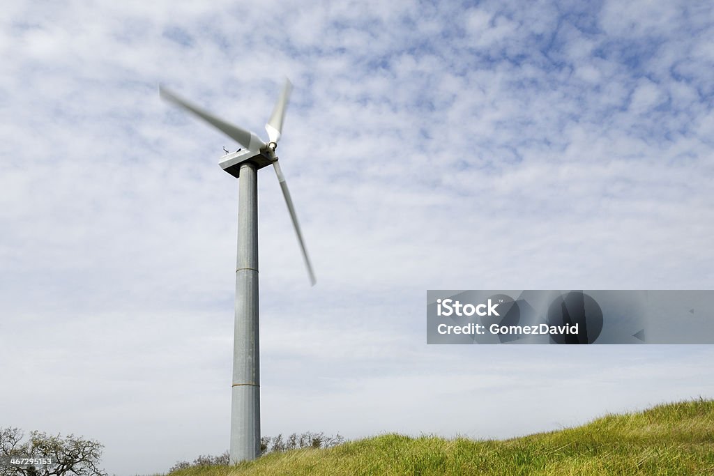 Wind Turbine On Hill Wind Turbine in the Pacheco Pass Wind Farm with spring grass growing atop the usually dry hills. California Stock Photo