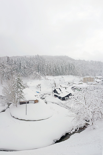 Small japanese village in winter. River bend: 