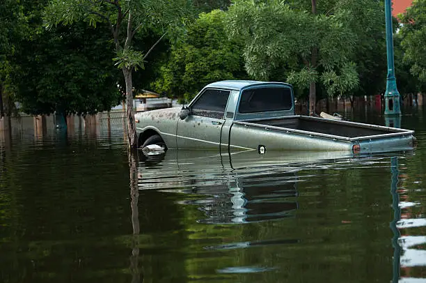 Flooded street with a pick up truck.