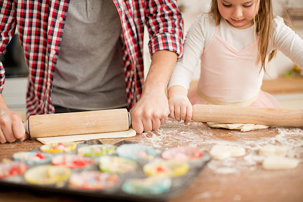 istock Father and daughter baking in kitchen. 467298490