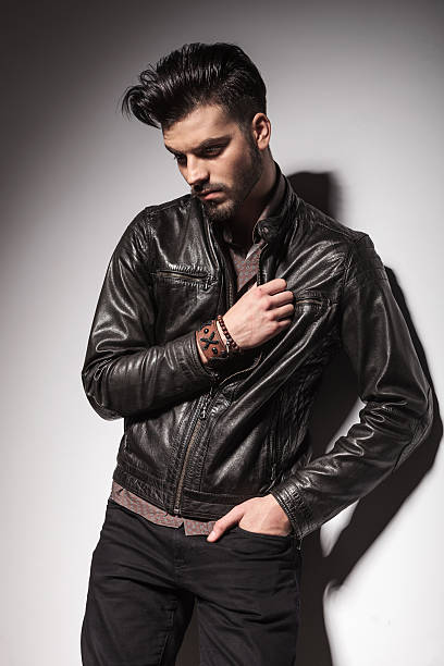 istock young fashion man leaning on a wall 467298632