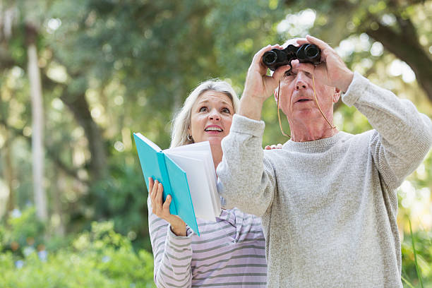 istock Senior couple in the woods birdwatching 467298668