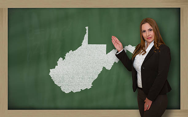 istock Teacher showing map of west virginia on blackboard 467299230