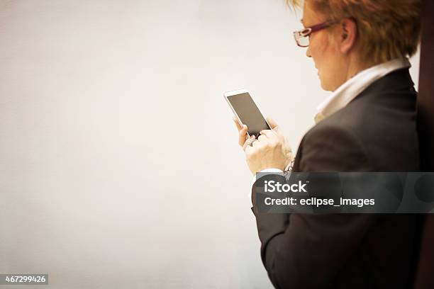 Using Smart Phone Stock Photo - Download Image Now - 2015, 50-59 Years, 55-59 Years