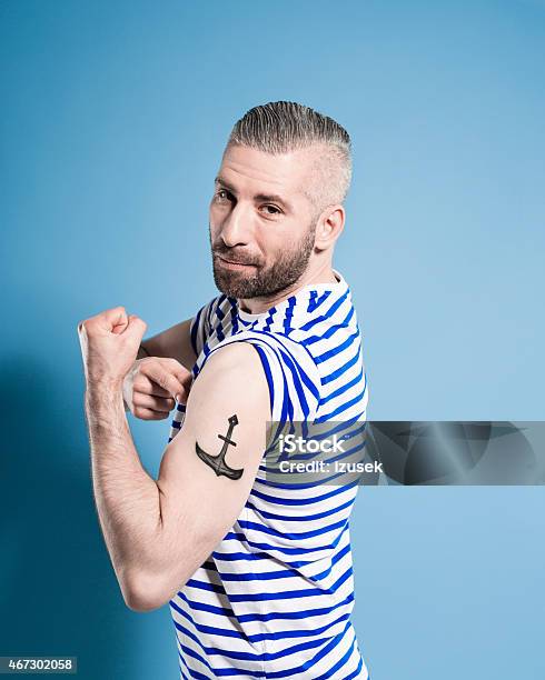 Bearded Sailor Man Showing His Anchor Tatoo Stock Photo - Download Image Now - Tattoo, Men, Showing