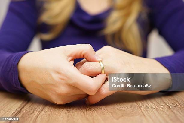 Woman Is Taking Off The Wedding Ring Stock Photo - Download Image Now - Breaking, Wedding, Engagement Ring