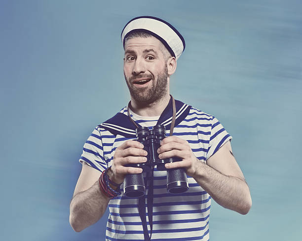 istock Bearded man in sailor style outfit holding binoculars 467302158