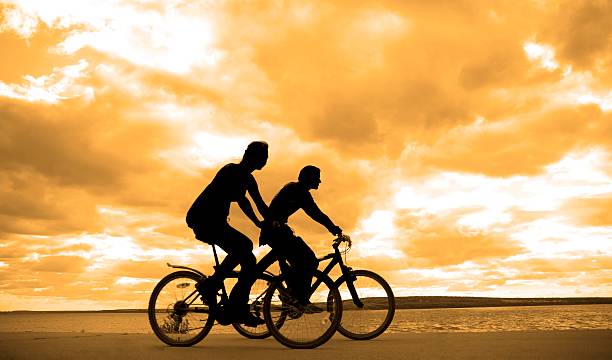 istock two active young adult sporty mountain biker silhouette 467302305