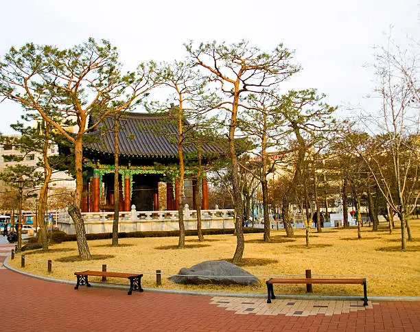 Photo of traditional korean pagoda with bell in central park