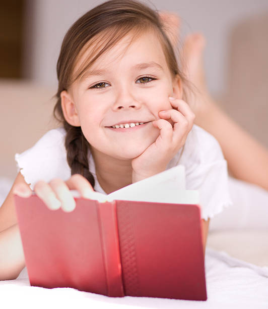 istock Little girl is reading a book 467305957