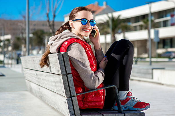 sport frau auf die promenade - women sweater vest beach pier stock-fotos und bilder