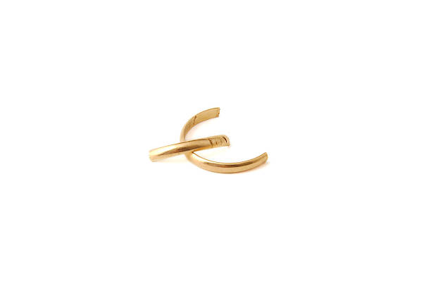 istock Broken wedding golden ring on white background. Divorce concept 467309796