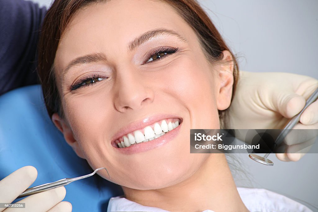 Woman smiling during a teeth examination at the dentist dental examination of attractive girl in the office of the dentist 2015 Stock Photo