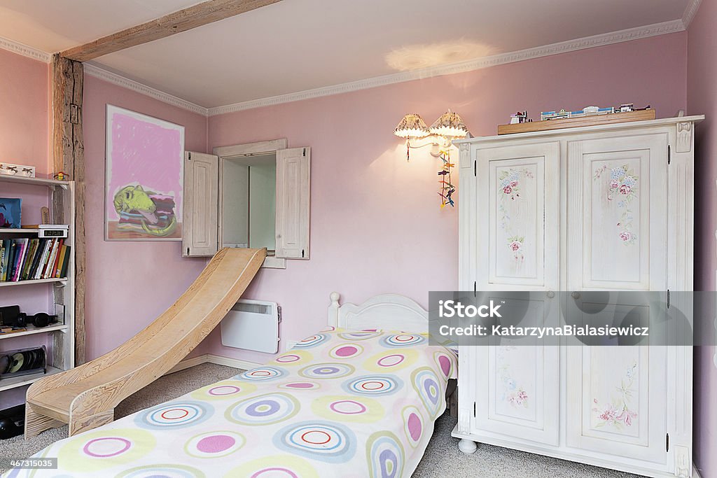 Vintage mansion - girl's room Vintage mansion - a pink girl's room with a slide, a bed and shelves Slide - Play Equipment Stock Photo