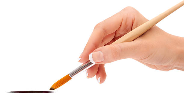istock Female hand holding paint brush isolated 467315053