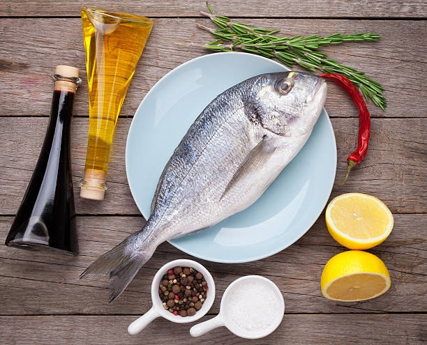 istock Fresh dorado fish cooking with spices and condiments 467315492